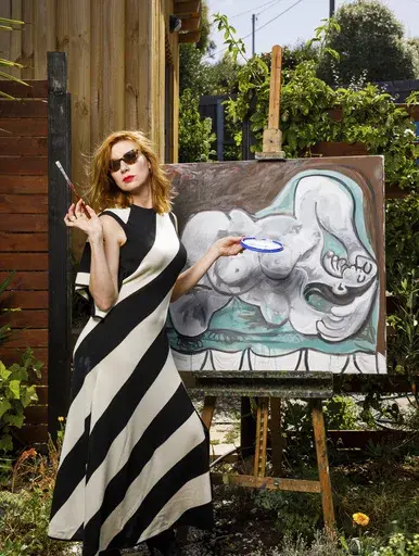 In this undated photo provided by the Museum of Old and New Art (MONA), Kirsha Kaechele poses with a painting in Hobart, Australia. Kaechele has divulged on July 9, 2024, that she was the creator of three paintings that she presented as works by Pablo Picasso -- and which prompted a gender discrimination case in Tasmania when she only permitted women gallery patrons to view them. (Jesse Hunniford/MONA via AP)