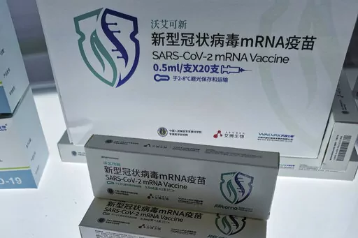 China's first SARS-CoV-2 mRNA vaccine AWcorna, developed by Abogen Biosciences, Walvax Biotechnology, and the Academy of Military Medical Sciences' Institute of Biotechnology, is displayed at the National 13th Five-Year Scientific and Technological Innovation Achievement Exhibition in Beijing, China on Oct. 27, 2021. More than two years into the pandemic, China has not approved the more effective mRNA vaccines, instead choosing to pursue its own route on COVID-19 vaccines. (Chinatopix via AP)