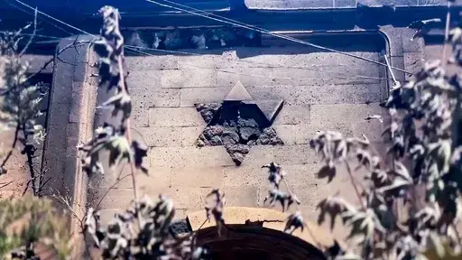 In this photo taken from video released by The Telegram Channel of the head of the Dagestan Republic of Russia on Monday, June 24, 2024, a damaged Star of David is seen on the wall of the the Kele-Numaz synagogue in Derbent, Russia. Jews in the predominantly Muslim region of Dagestan in southern Russia say they are determined to regroup and rebuild following a deadly attack by Islamic militants on June 23 on Christian and Jewish houses of worship in Derbent and the regional capital of Makhachkal