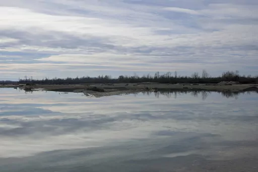 A view of the bank of the Drina River near the village of Amajlije, eastern Bosnia, Sunday, Feb. 4, 2024. In several cities along this river between Bosnia and Serbia, simple, durable gravestones now mark the final resting places of dozens of refugees and migrants who drowned in the area while trying to reach Western Europe. (AP Photo/Darko Vojinovic)