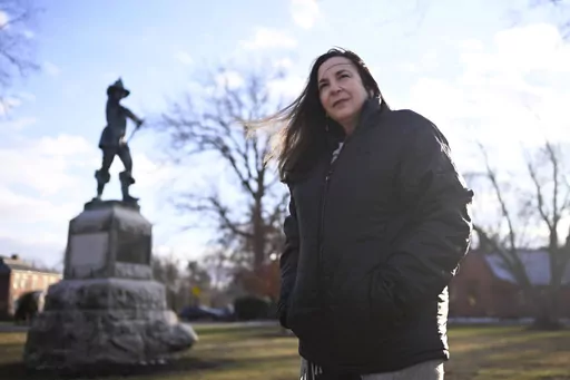 FILE — Beth Caruso, author and co-founder of the CT Witch Trial Exoneration Project, which was created to clear the names of the accused, stands on the Palisado Green in Windsor, Conn., Jan. 24, 2023. With distant family members looking on, Connecticut senators voted Thursday, May 25, 2023, to absolve the 12 women and men convicted of witchcraft -- 11 of whom were executed — more than 370 years ago and apologize for the “miscarriage of justice” that occurred over a dark 15-year-period of