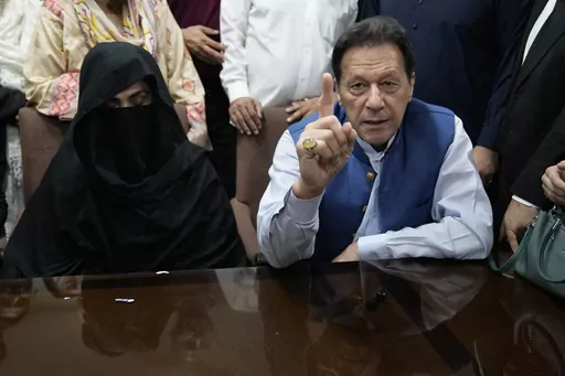 Pakistan's former Prime Minister Imran Khan, right, and Bushra Bibi,his wife, talk to the media before signing documents to submit surety bond over his bails in different cases, at an office of Lahore High Court in Lahore, Pakistan, on July 17, 2023. A Pakistani court on Wednesday, Wednesday, Jan. 31, 2024 sentenced former Prime Minister Khan and his wife Bibi to 14 years in prison for corruption, prison officials said, a day after another special court convicted Khan for leaking state secrets a