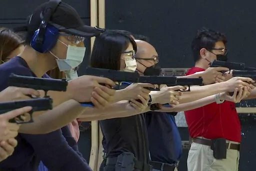 People shoot air soft guns at a private civilian training organization named Polar Light Training in New Taipei City, Taiwan on June 21, 2022. While an invasion doesn’t appear imminent, China's recent large-scale military exercises in response to a visit by U.S. House Speaker Nancy Pelosi to Taiwan have made the government in Taipei more aware than ever of the hard power behind Beijing’s rhetoric about bringing the self-ruled island under its control. Experts said that civilian defense and r