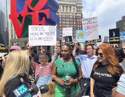 Actors Sheryl Lee Ralph, left, and Lisa Ann Walter, members of the cast of "Abbott Elementary," participate in a rally in support of the actors and writers strikes at Love Park in Philadelphia on Thursday, July 20, 2023. The actors strike comes more than two months after screenwriters began striking in their bid to get better pay and working conditions. (AP Photo/Tassanee Vejpongsa)