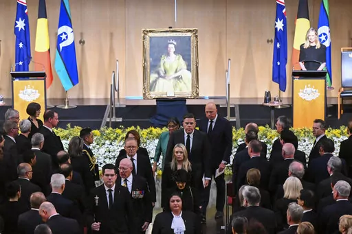 Australian Governor-General David Hurley, center left, and Australian Prime Minister Anthony Albanese, rear center left, leave at the end of the national memorial service for Queen Elizabeth II at Parliament House in Canberra, Thursday, Sept. 22, 2022. An Australian national day of mourning for the late Queen Elizabeth II on Thursday centered on Parliament House, where dignitaries placed sprigs of golden wattle, the national floral emblem, in a wreath. (Lukas Coch/AAP Image via AP)
