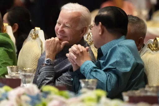 U.S. President Joe Biden, left, and Cambodian Prime Minister Hun Sen share a moment as they watch a cultural dance performance at the Association of Southeast Asian Nations (ASEAN) gala dinner, Saturday, Nov. 12, 2022, in Phnom Penh, Cambodia. Hun Sen said Tuesday, Nov. 15, 2022, he has tested positive for COVID-19 at the Group of 20 meetings in Bali, just days after hosting many world leaders, including President Joe Biden, for a summit in Phnom Penh. (AP Photo/Alex Brandon, File)
