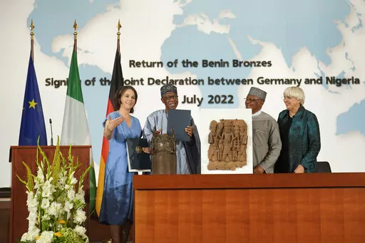 From left, German Foreign Minister Annalena Baerbock, Minister of Information and Culture of Nigeria Lai Mohammed, Nigerian Minister of State of Foreign Affairs Zubairo Dada and German Government Commissioner for Culture and the Media Claudia Roth pose for the media near two Benin Bronze sculptures after signing an agreement in Berlin, Germany, Friday, July 1, 2022. Germany and Nigeria signed an agreement in Berlin Friday paving the way for the return of centuries-old sculptures known as the Ben