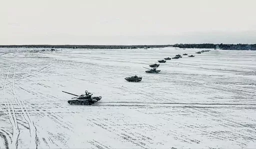 In this photo taken from video and released by the Russian Defense Ministry Press Service on Friday, Feb. 4, 2022, tanks and armored vehicles move during the Belarusian and Russian joint military drills at Brestsky firing range, Belarus. With Russia carrying out a massive military buildup near Ukraine and the West roundly rejecting Moscow’s security demands, a window for diplomacy in the crisis appears to be closing. But even as Moscow continues to bolster its forces and holds sweeping war gam