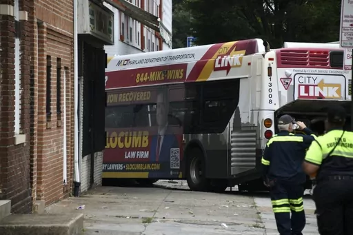 First responders work the scene of a multi-vehicle crash in Baltimore on Saturday, June 17, 2023. Police say several people were injured when a mass transit bus crashed with two cars before hitting a building. (Kim Hairston/The Baltimore Sun via AP)