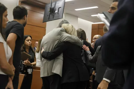 Tom and Gena Hoyer exit the courtroom as Gena could be heard sobbing following the verdict in the trial of Marjory Stoneman Douglas High School shooter Nikolas Cruz at the Broward County Courthouse in Fort Lauderdale, Fla., on Thursday, Oct. 13, 2022. The Hoyer's son, Luke, was killed in the 2018 shootings.  A jury spared Cruz from the death penalty Thursday for killing 17 people at a Parkland high school in 2018, sending him to prison for the remainder of his life. (Amy Beth Bennett/South Flori