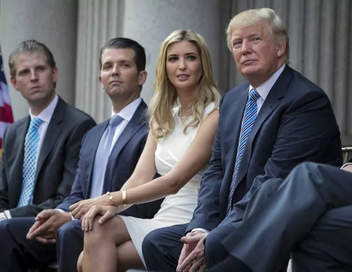 Donald Trump, right, sits with his children, from left, Eric Trump, Donald Trump Jr., and Ivanka Trump during a groundbreaking ceremony for the Trump International Hotel on July 23, 2014, in Washington. A New York appeals court dismissed Ivanka Trump on Tuesday, June 27, 2023, from a wide-ranging fraud lawsuit brought against her father and his company last year by the state's attorney general. (AP Photo/Evan Vucci, File)