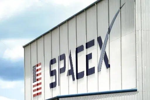 a SpaceX logo is displayed on a building on May 26, 2020, at the Kennedy Space Center in Cape Canaveral, Fla. SpaceX, the rocket ship company run by Tesla CEO Elon Musk, has fired several employees involved in an open letter that blasted the colorful billionaire for his behavior, according to media reports Friday, June 17, 2022. (AP Photo/David J. Phillip, File)