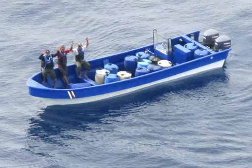 In this photo obtained from U.S. federal court records, Jeffri Dávila-Reyes, third from left, and two others hold their hands in the air as they are intercepted in the Caribbean Sea on Oct. 29, 2015. Dávila-Reyes says he’s still mystified how he ended up serving hard time in a U.S. federal prison. His cocaine bust at sea was closer to his homeland of Costa Rica than the United States, and the few kilos of drugs he was carrying were bound for Jamaica rather than American shores. (U.S. Coast G