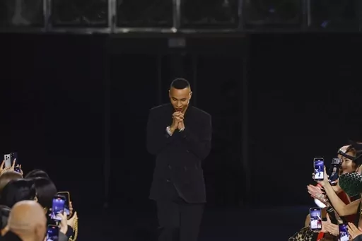 Designer Olivier Rousteing accepts applause after the conclusion of the Balmain Fall/Winter 2023-2024 ready-to-wear collection presented Wednesday, March 1, 2023 in Paris. Balmain artistic director Olivier Rousteing says robbers have made off with more than 50 pieces of the new collection that his Paris house intends to show at Fashion Week later this month. (Vianney Le Caer/Invision/AP, file)