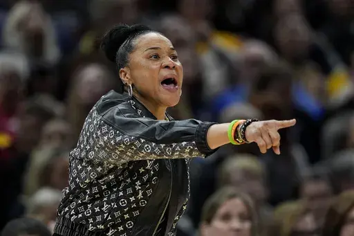 FILE- South Carolina head coach Dawn Staley directs her team during the second half of a Final Four college basketball game against North Carolina State in the women's NCAA Tournament, Friday, April 5, 2024, in Cleveland. (AP Photo/Carolyn Kaster, File)