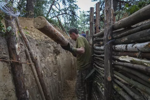 Ukrainian servicemen strengthen trenches on their position near the frontline in Kharkiv region, Ukraine, Tuesday, July, 5, 2022. (AP Photo/Andrii Marienko)