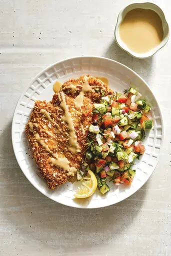This image released by Clarkson Potter shows a recipe for Sesame Schnitzel, featured in the cookbook "Eitan Eats the World" by Eitan Bernath. (Mark Weinberg/Clarkson Potter via AP)