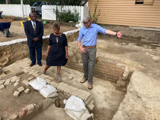 From left, Reginald F. Davis, pastor of First Baptist Church, Connie Matthews Harshaw, a member of First Baptist, and Jack Gary, Colonial Williamsburg's director of archaeology, stand at the brick-and-mortar foundation of one the oldest Black churches in the U.S. on Oct. 6, 2021, in Williamsburg, Va. Experts announced Thursday, April 6, 2023, that three men whose graves were found at the site were members of the church in the early 19th Century. (AP Photo/Ben Finley, File)