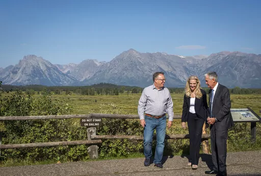 Federal Reserve Chair Jerome Powell, right, walks with with Federal Reserve Vice Chair Lael Brainard, center, and Federal Reserve Bank of New York president and CEO John Williams, left, at the central bank's annual symposium in Grand Teton National Park Friday, Aug. 26, 2022. in Moran, Wyo. (AP Photo/Amber Baesler)