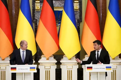 Ukrainian President Volodymyr Zelenskyy, right, and German Chancellor Olaf Scholz attend their joint news conference following talks at The Mariinskyi Palace in Kyiv, Ukraine, Monday, Feb. 14, 2022. German Chancellor Olaf Scholz visited Ukraine as part of a flurry of Western diplomacy aimed at heading off a feared Russian invasion that some warn could be just days away. (AP Photo/Efrem Lukatsky)