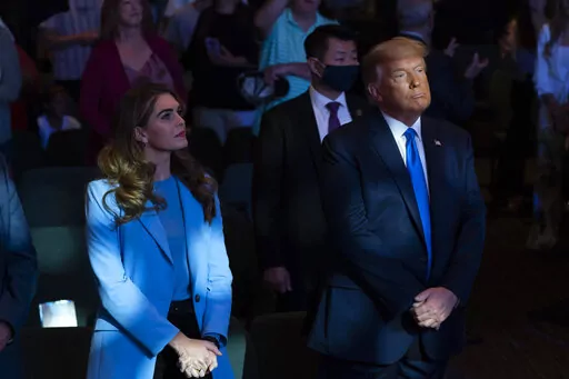 President Donald Trump attends church at International Church of Las Vegas with counselor Hope Hicks, left, Sunday, Oct. 18, 2020, in Las Vegas, Nev. Hicks, Trump's former spokeswoman, met Monday, March 6, 2023, with Manhattan prosecutors investigating hush-money payments made on the ex-president's behalf — the latest member of the Republican's inner circle to be questioned in the renewed probe. (AP Photo/Alex Brandon, File)