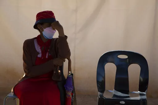 A woman waits in a queue to be screened for COVID-19 at a testing centre in Soweto, South Africa, Wednesday, May 11, 2022. Health experts in South Africa say the country is experiencing a surge of new COVID-19 cases driven by two omicron sub-variants. Professor Marta Nunes, a researcher at Vaccine and Infectious Diseases Analytics at Chris Hani Baragwanath Hospital in Soweto said that for about three weeks the country has seen increasing numbers of new cases and somewhat higher hospitalizations,