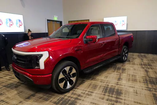 The Ford F-150 Lightning is displayed at the M1 Concourse car club, Wednesday, Jan. 11, 2023, in Pontiac, Mich. The vehicle won the 2023 North American Truck of the Year during an awards ceremony Wednesday. (AP Photo/Carlos Osorio)