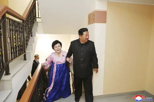 In this photo provided by the North Korean government, Kim Jong Un visits the new house of Korean Central Broadcasting announcer Ri Chun Hi, second right, after attending an inauguration ceremony of Pothong riverside terraced residential district in Pyongyang, North Korea Wednesday, April 13, 2022. Independent journalists were not given access to cover the event depicted in this image distributed by the North Korean government. The content of this image is as provided and cannot be independently