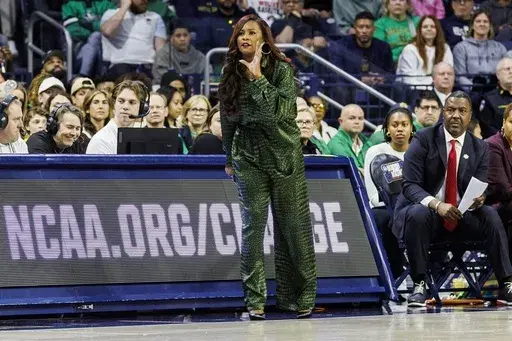 Notre Dame head coach Niele Ivey, center, shouts instructions during the first half against Michigan in the second round of the NCAA college basketball tournament Sunday, March 23, 2025, in South Bend, Ind. (AP Photo/John Mersits)