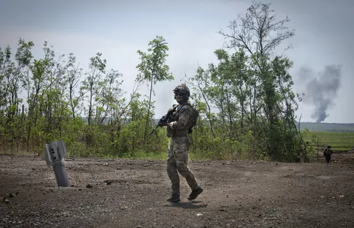 Ukrainian soldiers walk in their positions on the frontline in Zaporizhzhia region, Ukraine, Friday, June 23, 2023. In the southeastern Zaporizhzhia region, Ukrainian troops - backed by tanks, artillery and drones - have broken through initial Russian fighting positions and continue to make steady gains south of Velyka Novosilka near the administrative border with Donestk and south of Orikhiv, while confronting heavy bombardment in wide open fields with little cover. (AP Photo/Efrem Lukatsky, Fi