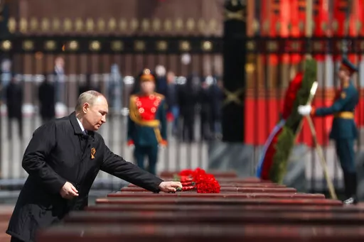 Russian President Vladimir Putin attends a wreath-laying ceremony at the Tomb of the Unknown Soldier after the military parade marking the 77th anniversary of the end of World War II in Moscow, Russia, Monday, May 9, 2022. (Anton Novoderezhkin, Sputnik, Kremlin Pool Photo via AP)