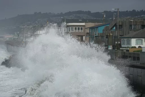 Large waves crash into a seawall in Pacifica, Calif., on Jan. 6, 2023. Giant waves, measuring as high as 13 feet, are becoming more common off California's Pacific coast as the planet warms, according to new research that used a unique approach to gather historical data over the past 90 years to track the increasing height of the surf. (AP Photo/Jeff Chiu, File)