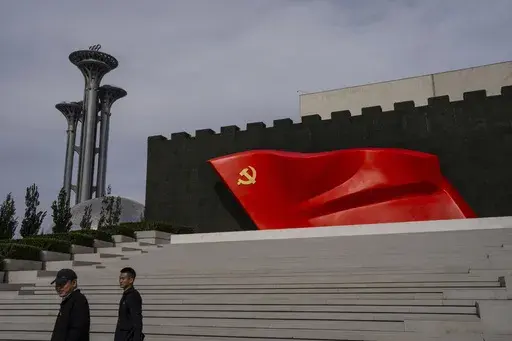Visitors pass the Chinese Communist Party flag at the museum of the Communist Party of China in Beijing, Oct. 19, 2023. (AP Photo/Louise Delmotte, File)