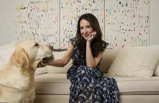 Author Allison Winn Scotch is joined by her dog Mr. Peanut as she poses for a portrait at home, Monday, Feb. 26, 2024, in Los Angeles. (AP Photo/Chris Pizzello)