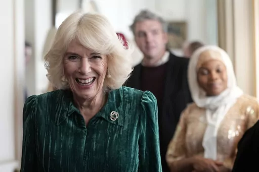 Britain's Queen Camilla arrives with invited children supported by Helen & Douglas House and Roald Dahl's Marvellous Children's Charity to decorate the Christmas tree and receive a few festive surprises at Clarence House in London, Wednesday, Dec. 6, 2023. Queen Camilla, once seen as the scourge of the House of Windsor, the woman at the heart of King Charles III’s doomed marriage to the late Princess Diana, has emerged as one of the monarchy’s most prominent emissaries. (AP Photo/Kin Cheung,