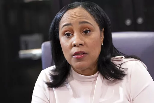 Fulton County Georgia District Attorney Fani Willis is photographed in her office in Atlanta, on Jan. 4, 2022. Willis is investigating whether Trump and others illegally tried to influence the 2020 election in Georgia. As part of the probe, Willis filed court documents on Friday, Sept. 2, 2022, seeking testimony from Willie Lewis Floyd, a director of Black Voices for Trump, a group aimed at increasing the former president's support among Black voters. (AP Photo/Ben Gray, File)