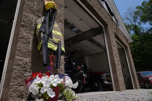 Flowers and a tribute to fallen firefighter Corey Comperatore are pictured at the Buffalo Township Volunteer Fire Company in Buffalo Township, Pa., Monday, July 15, 2024. Comperatore was shot and killed at the Trump rally in Butler, Pa., Saturday, July 13, 2024. (AP Photo/Sue Ogrocki)