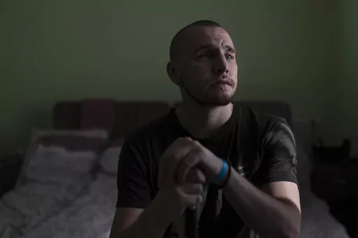 Ivan Soroka, a 27-year-old former Ukrainian soldier blinded in the war, sits for a photo in his room at a rehabilitation center designed for soldiers who lost their vision on the battlefield, near Rivne, Ukraine, Friday, July 21, 2023. Over the course of several weeks, the veterans, accompanied by their families, reside at the rehabilitation center. Most receive their first canes here, take their first walks around urban and natural environments without assistance, and learn to operate programs 