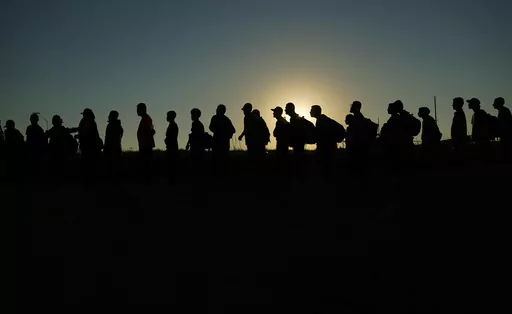 Migrants who crossed the Rio Grande and entered the U.S. from Mexico are lined up for processing by U.S. Customs and Border Protection, Sept. 23, 2023, in Eagle Pass, Texas. A federal judge on Thursday, Feb. 29, 2024 blocked a new Texas law that gives police broad powers to arrest migrants suspected of illegally entering the U.S., dealing a victory to the Biden administration in its feud with Republican Gov. Greg Abbott over immigration enforcement. (AP Photo/Eric Gay, file)
