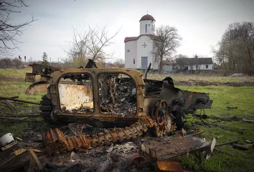 Fragments of a destroyed Russian military vehicle lie against the background of an Orthodox church in the village of Lypivka close to Kyiv, Ukraine, on April 11, 2022. Lypivka was occupied by the Russian troops at the beginning of the Russia-Ukraine war and freed recently by the Ukrainian army. Many Americans continue to question whether President Joe Biden is showing enough strength in response to Russia’s war against Ukraine, even as most approve of steps the U.S. is already taking and few w