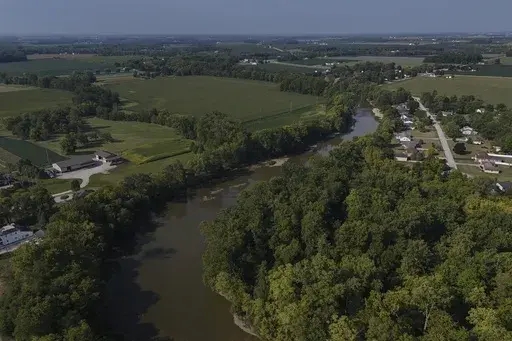 Water flows down the Sandusky River between farms, Aug. 26, 2024, in Fremont, Ohio. (AP Photo/Joshua A. Bickel, File)