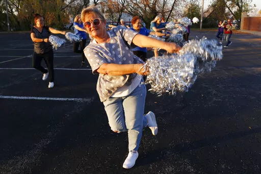 Pam Junion, 65, and other members of the Milwaukee Dancing Grannies practice in a parking lot in Milwaukee on Wednesday, Nov. 2, 2022. Junion is one of a few women who answered a call for new members as the group attempted to rebuild in the face of tragedy. Three Dancing Grannies and one group member’s husband were among those killed at a Christmas parade in Waukesha, Wisconsin, when the driver of an SUV struck them on the parade route. Dozens more, including some Grannies, were injured. (AP P