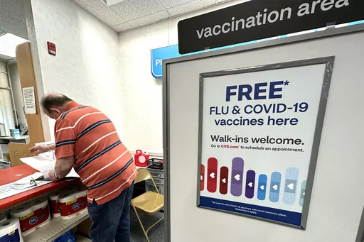 A sign for flu and covid vaccinations is displayed at a pharmacy store in Palatine, Ill., Wednesday, Sept. 13, 2023. The flu is hanging on in the U.S., intensifying in some areas of the country after weeks of apparent decline., according to data released by the U.S. Centers for Disease Control and Prevention on Friday, Feb. 9, 2024. (AP Photo/Nam Y. Huh, File)