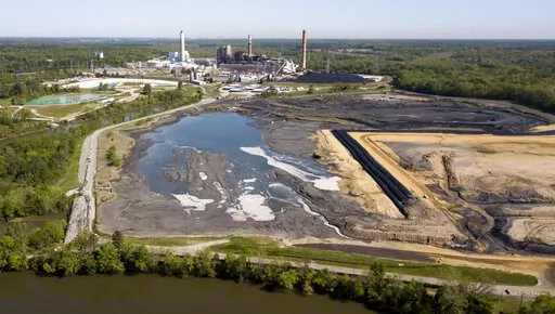 In this May 1, 2018, file photo, the Richmond, Va., city skyline is seen in the horizon behind the coal ash ponds along the James River near Dominion Energy's Chesterfield Power Station in Chester, Va. In the first first major action to address toxic wastewater from coal-burning power plants, the Environmental Protection Agency is denying requests by three Midwest power plants to extend operations of leaking or otherwise dangerous coal ash storage ponds. (AP Photo/Steve Helber, File)