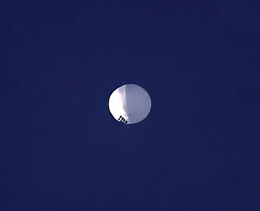 ADDS PENTAGON RESPONSE THAT IT WOULD NOT CONFIRM - A high altitude balloon floats over Billings, Mont., on Wednesday, Feb. 1, 2023. The U.S. is tracking a suspected Chinese surveillance balloon that has been spotted over U.S. airspace for a couple days, but the Pentagon decided not to shoot it down due to risks of harm for people on the ground, officials said Thursday, Feb. 2, 2023. The Pentagon would not confirm that the balloon in the photo was the surveillance balloon. (Larry Mayer/The Billin