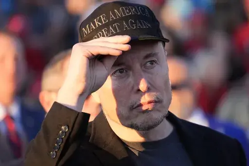Elon Musk listens as Republican presidential nominee former President Donald Trump speaks at a campaign event at the Butler Farm Show on Oct. 5, 2024, in Butler, Pa. (AP Photo/Alex Brandon, File)