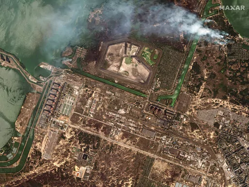 This satellite image provided by Maxar Technologies shows bush fires outside of the main power plant facilities at the Zaporizhzhia nuclear plant in Russian occupied Ukraine, Monday Aug. 29, 2022. A team from the U.N. nuclear watchdog on Monday started its journey to the Zaporizhzhia atomic power plant at the heart of fighting in Ukraine, a long-awaited mission to inspect crucial safety systems that the world hopes will help avoid a catastrophe. (Satellite image ©2022 Maxar Technologies via AP)