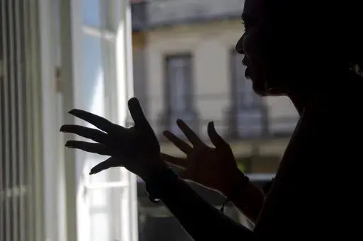 Diana gives an interview in Havana, Cuba, Thursday, Nov. 3, 2022. Diana said she endured screams, insults and confinement for seven years before she ended a seven year relationship with her boyfriend, but that she did not reach out to any institutions or programs that handled cases of violence against women because she had no faith that they could protect her. Diana asked that her last name not be published because she was afraid for her safety.  (AP Photo/Ismael Francisco)
