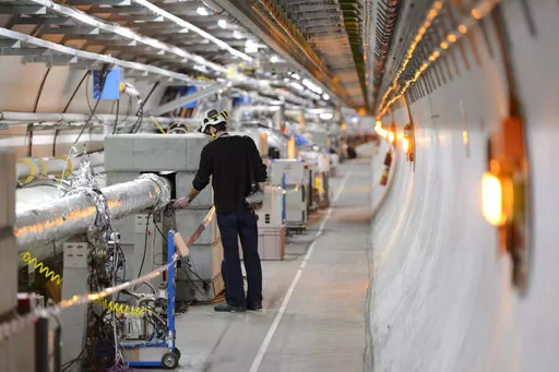 A technician works in the LHC (Large Hadron Collider) tunnel of the European Organization for Nuclear Research, CERN, during a press visit in Meyrin, near Geneva, Switzerland, Tuesday, Feb. 16, 2016. CERN, the sprawling Geneva-area research center that houses the world’s largest atom smasher, is grappling with how to best join international action against Russia for its allegedly inhumane invasion of Ukraine without sacrificing science that serves humanity. A decision on the right balance to s