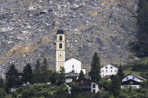 General view of part of the village of Brienz-Brinzauls below the rockfall "Brienzer Rutsch", in Switzerland, Friday, June 16, 2023. On Thursday night, a large part of the rock masses fell towards the village. The rock masses just missed the village and left behind a meter-high deposit on the main road near the school building. No one was injured since the village was evacuated on May 12. (Michael Buholzer/Keystone via AP)